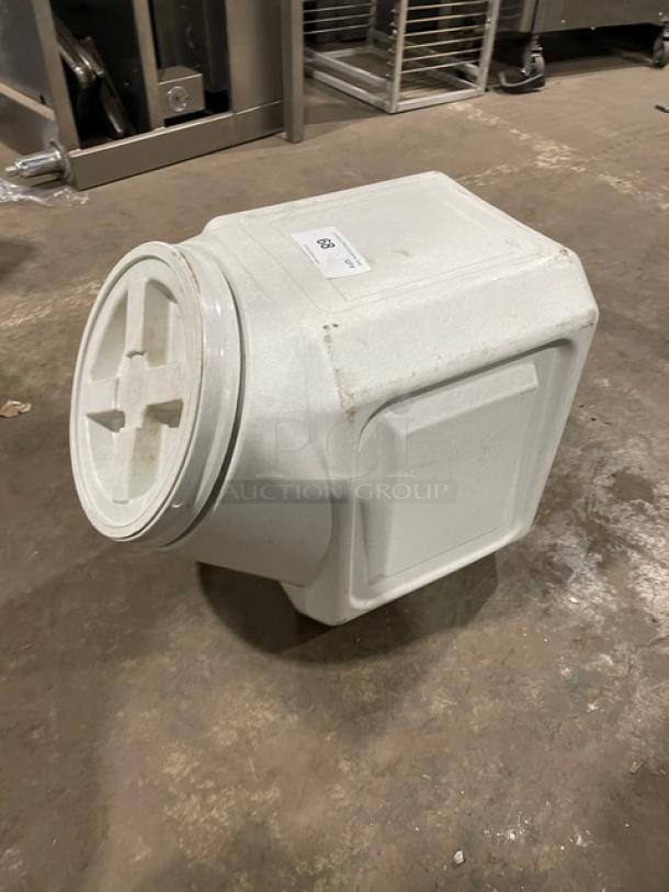 Commercial stackable countertop ingredient bin with twist-off top, white, durable plastic, used condition, visible label.