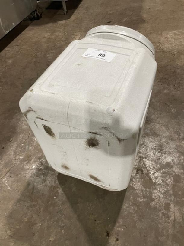 Stackable countertop ingredient bin with twist-off top, used condition, minor surface marks. Auction label visible.