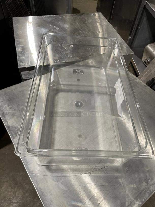 Clear polycarbonate Cambro food pan, commercial-grade. New condition, rectangular shape, visible capacity markings.