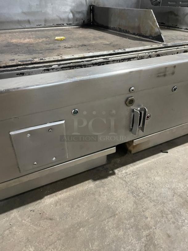 WoodStone stainless steel countertop flat griddle, model WSPL48364CT, natural gas, split top, used condition, with back and side splash.