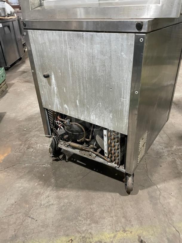 True stainless steel undercounter refrigerator, model TUC-27, with chrome-plated rack, on casters, 115V 1 phase.