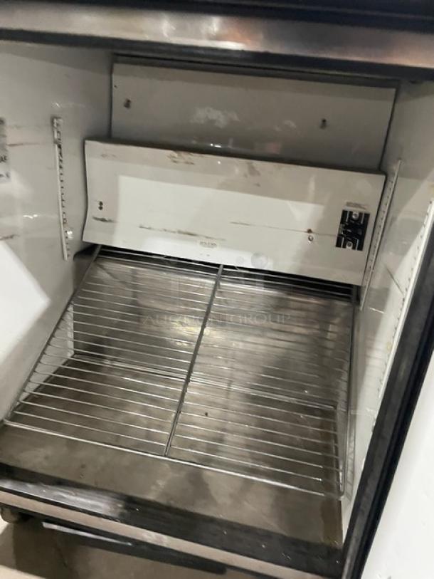 True TUC-27 undercounter refrigerator, stainless steel, single door, chrome-plated wire rack, on casters, model TUC-27.