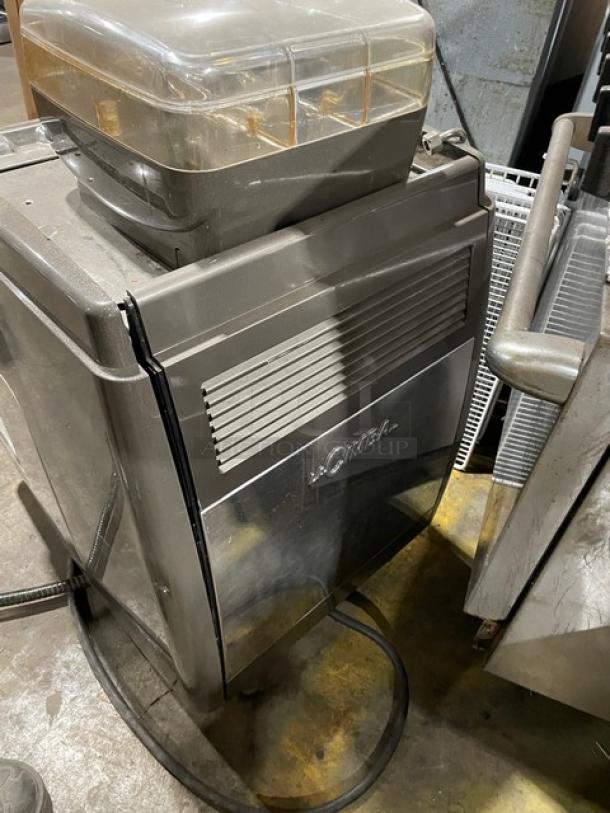 LaCimbali commercial espresso machine with stainless steel steam wand, clear bean hopper, and drip tray. Positioned on legs.