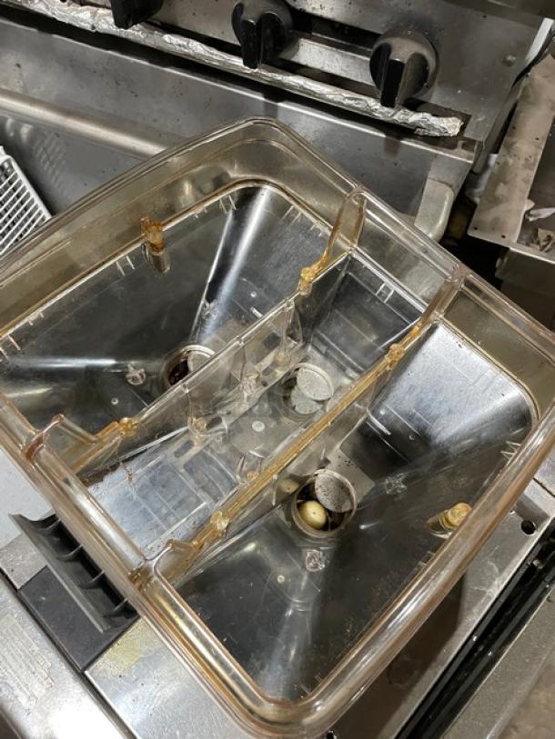 LaCimbali commercial espresso machine with clear bean hopper, stainless steel steam wand, and drip tray, shown on legs.