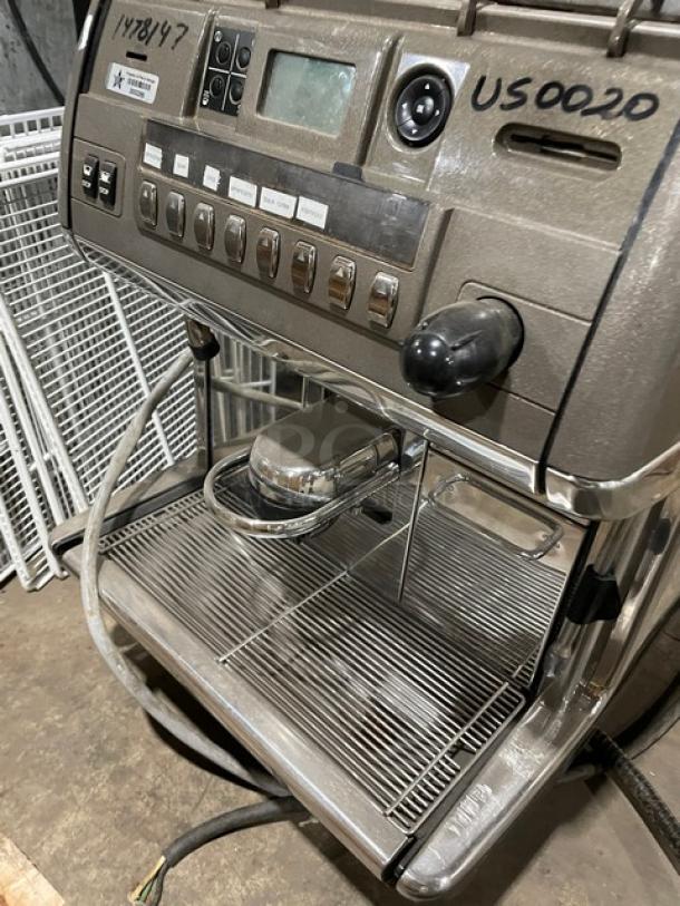 LaCimbali commercial espresso machine, automatic, with stainless steel steam wand, drip tray, clear bean hopper, on legs.
