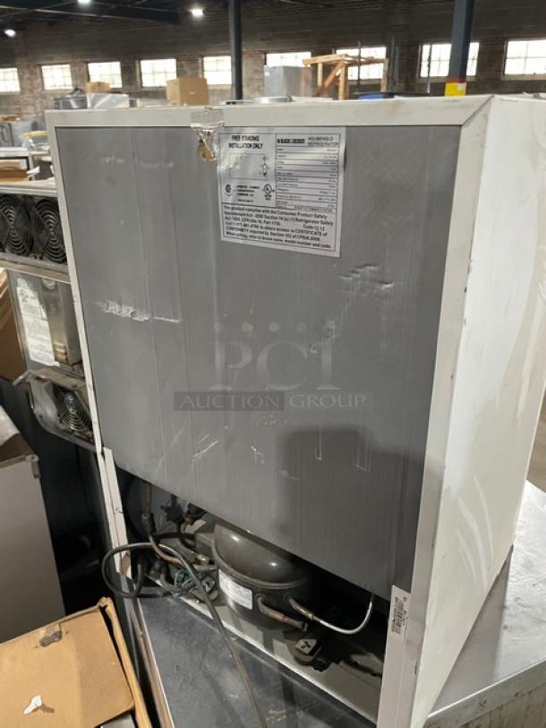 Black & Decker white free-standing refrigerator, Model BCFA27, with upper freezer, poly-coated wire rack, 115V, back view.