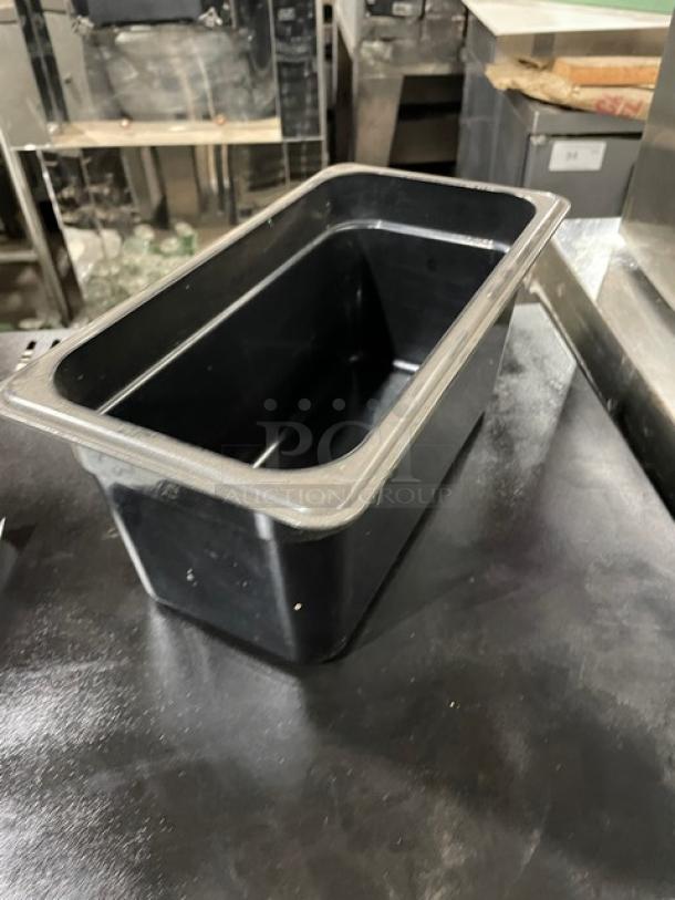 Cambro commercial black food pan, durable plastic, rectangular shape, clean condition, ideal for kitchen use.