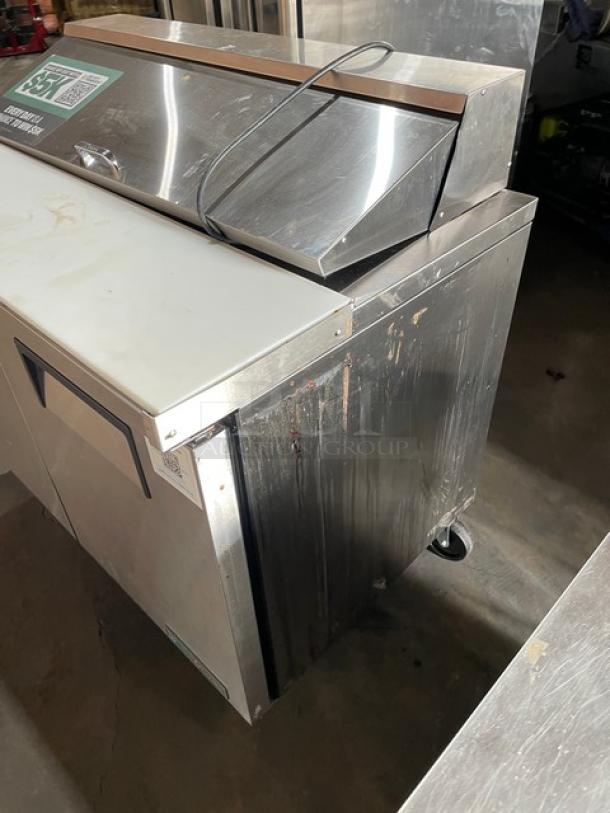 True Commercial Stainless Steel 2-Door Refrigerated Bain Marie Salad/Sandwich Prep Table, Model TSSU-48-12-HC, with Cutting Board, on Casters. Condition shows some wear on surface.
