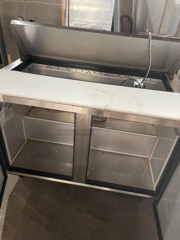 True Commercial Stainless Steel 2 Door Prep Table, Model TSSU-48-12-HC, with cutting board, on casters, 115V 1 Phase.