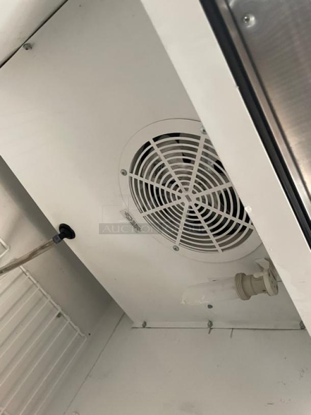 True T-23F commercial freezer interior, showing a fan, poly coated wired rack, and durable stainless steel construction.