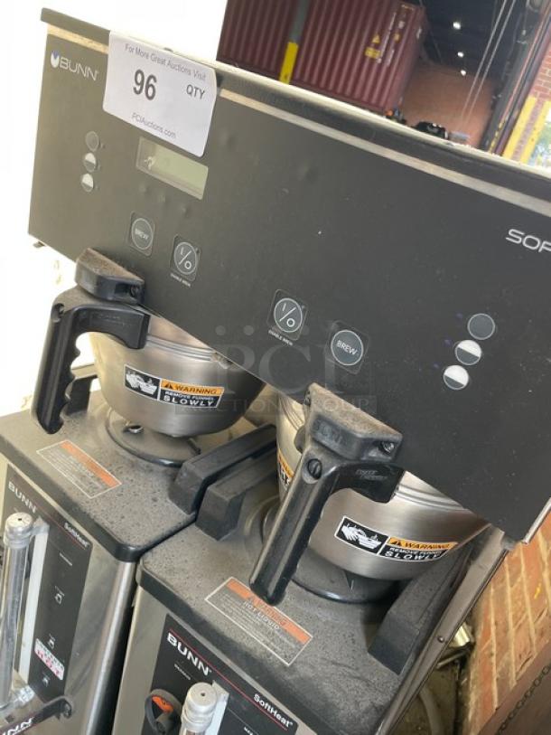 Bunn Soft Heat Series Dual Coffee Brewer, Model DUAL SH DBC, stainless steel, with hot water dispenser and portable servers, on legs.