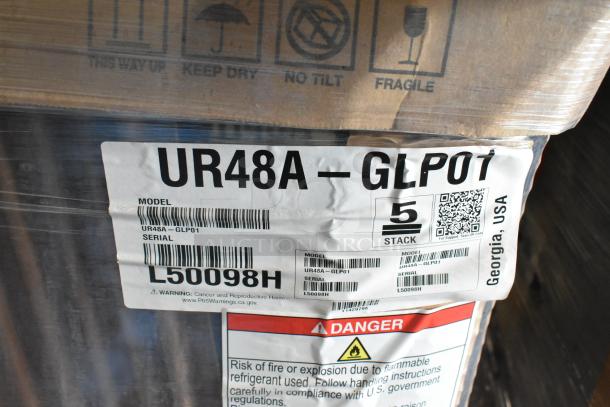 Brand new Hoshizaki UR48A-GLP01 2-door undercounter cooler in box. Label shows model, serial no. L50098H, and handling warnings.