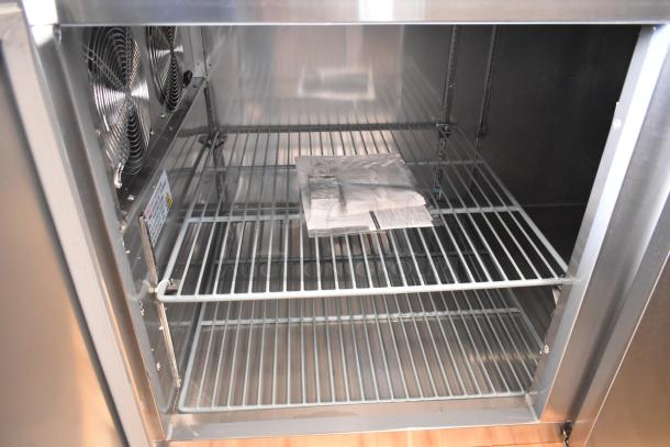 Brand new Avantco 178SSPPT3 stainless steel pizza prep table interior with shelves, 115V, scratch and dent condition.