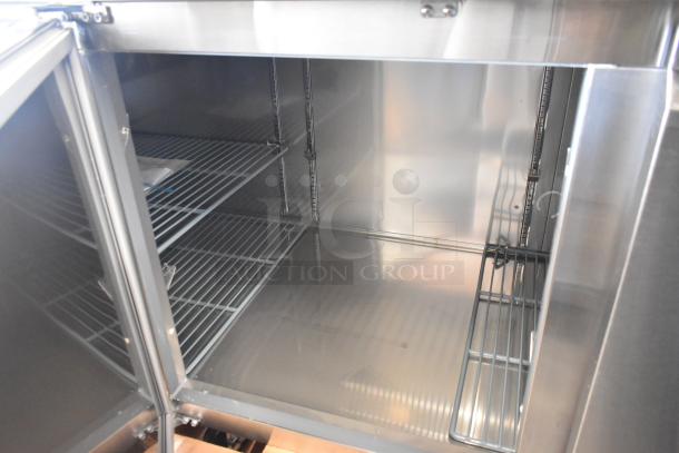 Brand new scratch and dent Avantco 178SSPPT3 stainless steel commercial pizza prep table, 115V, 1 phase, interior view.