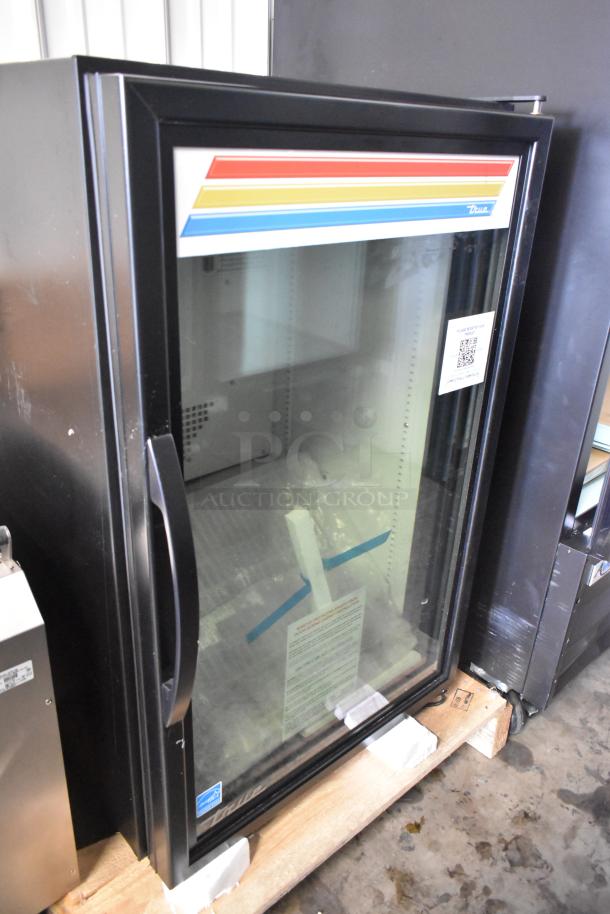 Brand new 2025 True GDM-07F-HC commercial mini freezer, glass door, poly coated racks, 115V, slight scratches visible.
