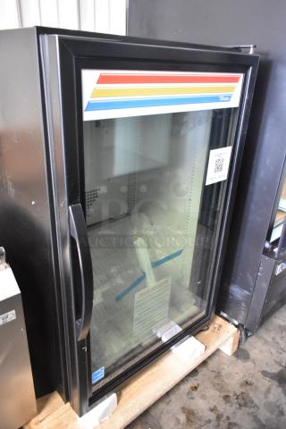 Brand new 2025 True GDM-07F-HC commercial mini freezer, glass door, poly coated racks, 115V, slight scratches visible.