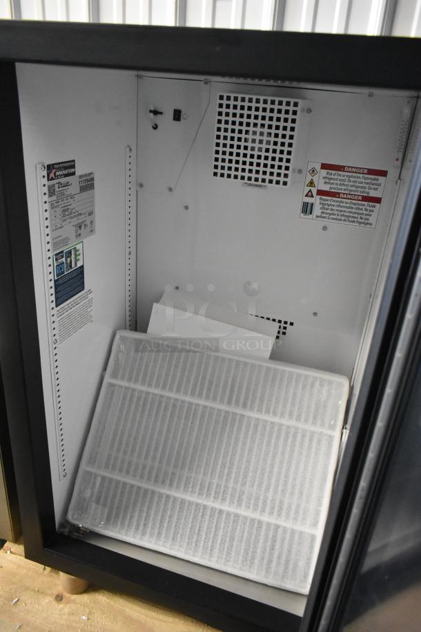 Brand new True GDM-07F-HC mini freezer with poly-coated racks, 115 volts, 1 phase, scratch and dent. Interior labels displayed.