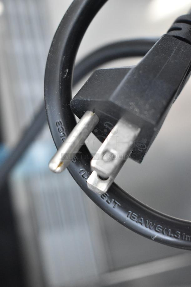 Black power cord with standard plug, part of the 2023 Vollrath RDE7160 60" curved glass refrigerated display cabinet, 120V, 1 phase.