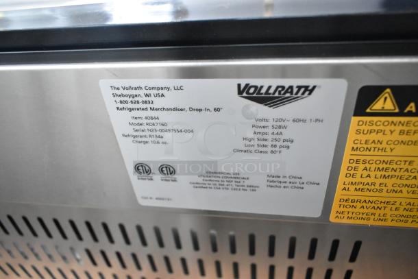 Alt text: "Label on a 2023 Vollrath RDE7160 refrigerated display cabinet showing model details and specifications."