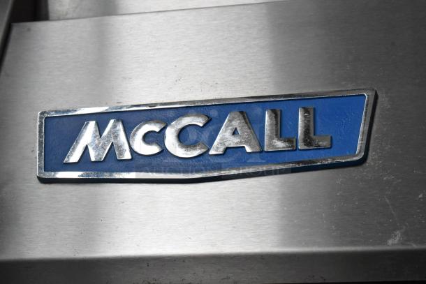 McCall 4-4045F Stainless Steel Commercial Freezer, 2 Doors, Poly Coated Racks, 115V, 1 Phase. Featured McCall logo.