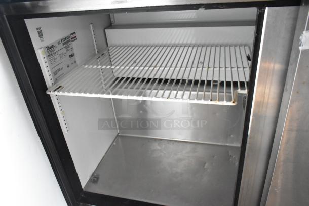 True TUC-48F-LP stainless steel undercounter freezer with two doors, shelving shown inside. 115 volts, 1 phase, model details visible.