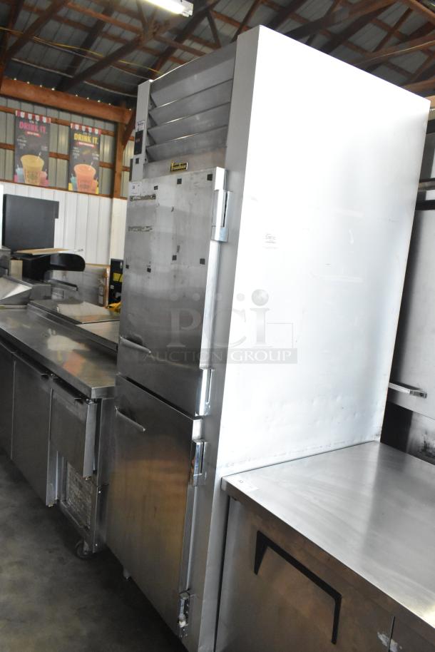 Traulsen G12000 stainless steel reach-in freezer with two half-size doors, poly-coated racks, 115V, 1 phase.