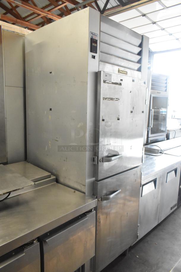 Traulsen G12000 stainless steel commercial freezer, 2 half-size doors, poly-coated racks, 115V, 1 phase, used condition.