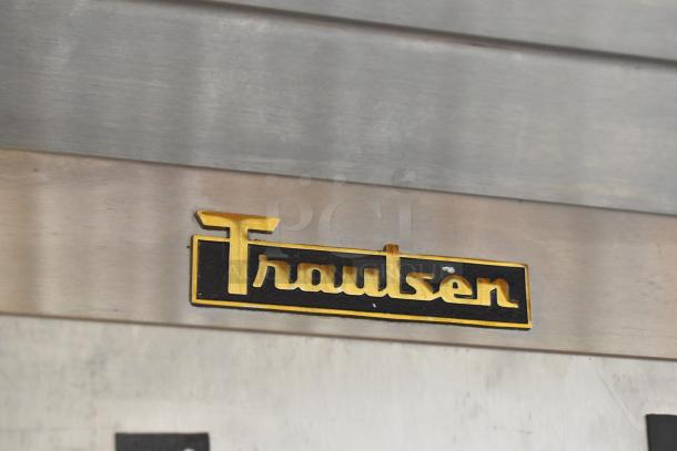 Traulsen G12000 commercial freezer, stainless steel, 2 half-size doors, poly-coated racks, with brand logo detail.