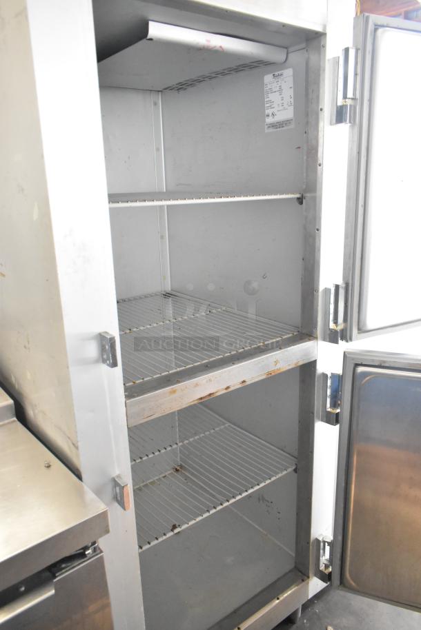 Traulsen G12000 stainless steel commercial freezer, 2 half doors, poly-coated racks, internal label, 115V, 1-phase.