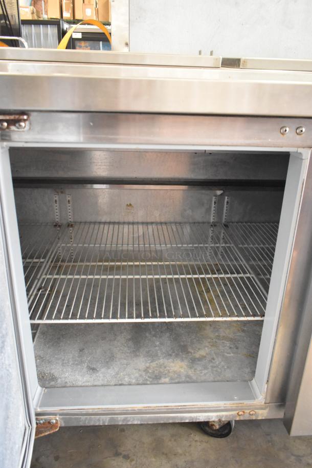 2016 Continental CPA93 stainless steel pizza prep table, commercial casters, 115V, 1 phase, interior shelf, good condition.