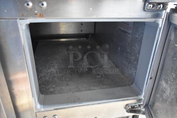 2016 Continental CPA93 stainless steel commercial pizza prep table interior, showing shelving and stainless surfaces.