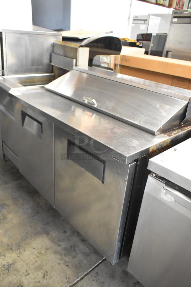 True TSSU-48-12 stainless steel commercial sandwich salad prep table on casters, 115V, 1 phase, visible wear.