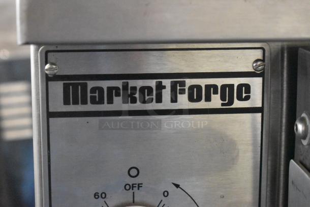 Market Forge 3500 stainless steel steam cabinet label, highlighting brand name on control panel.