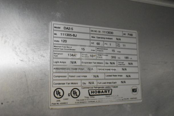 Hobart DA2-5 stainless steel commercial 2-door cooler merchandiser label, 115V, 1 phase, model info and specs visible.