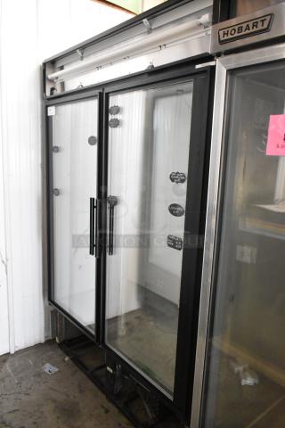 True GDM-49 commercial 2-door cooler, glass front, metal frame, 115 volts, 1 phase, clean condition, visible tags.