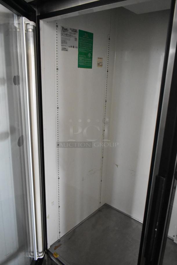 True GDM-49 metal commercial 2 door cooler, reach-in merchandiser, 115 volts, 1 phase, interior labels visible.