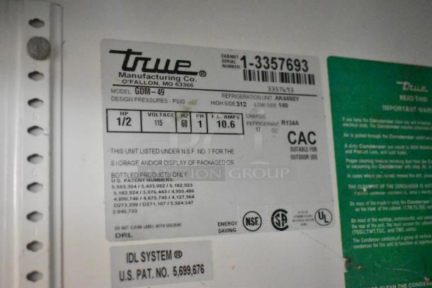 True GDM-49 2 Door Cooler, 115V, 1 Phase, label showing model, voltage, amps, refrigerant R134A, serial number 1-3357693.