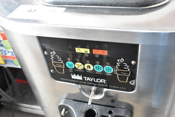 Taylor C706-27 stainless steel commercial soft serve machine, air-cooled, 208-230V, 1 phase, control panel visible.