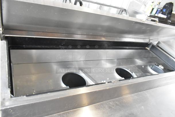 True TPP-67 stainless steel commercial pizza prep table with open lid, on commercial casters, 115 volts, 1 phase.