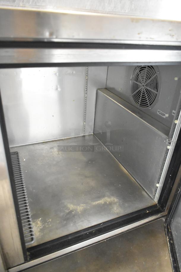 True TPP-67 stainless steel pizza prep table interior. Includes ventilation fan. 115V, 1 phase, on commercial casters.
