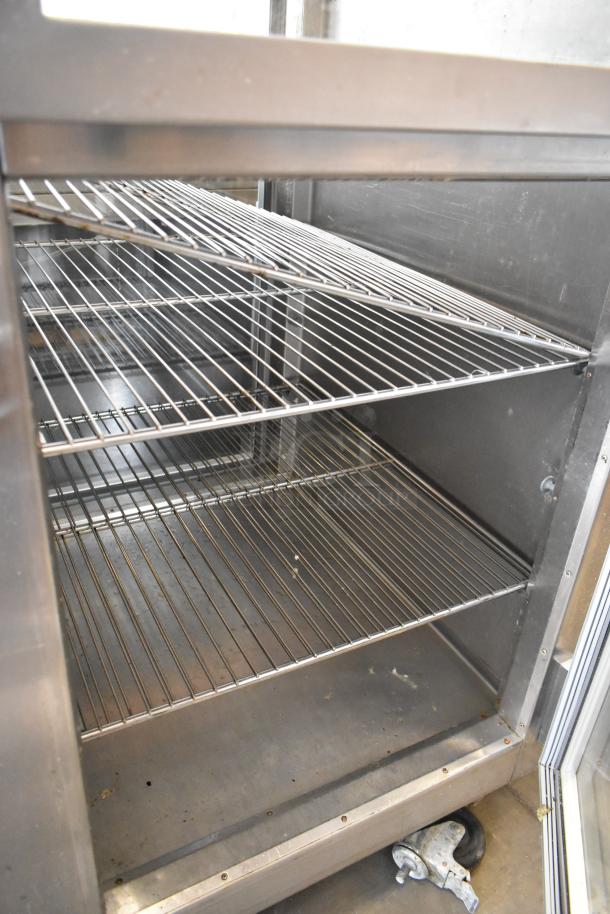 Traulsen RHT132WPTHHG stainless steel commercial refrigerator interior with wire shelves, 115 volts, one phase.