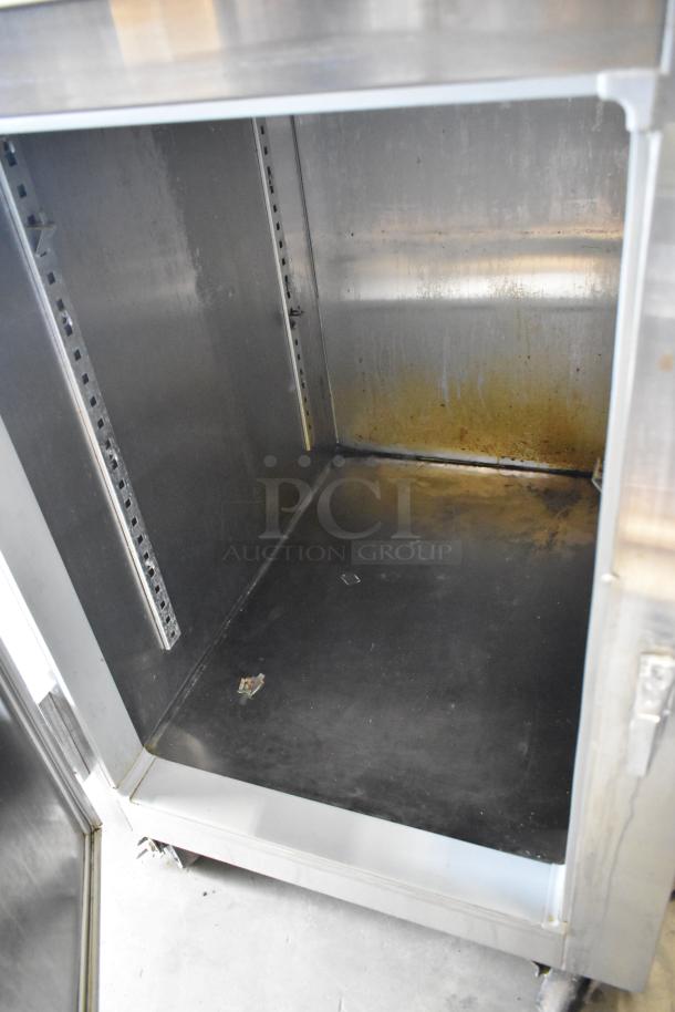 Traulsen stainless steel commercial reach-in cooler with two half-size doors, on casters. Used condition. 115V, 1 phase.