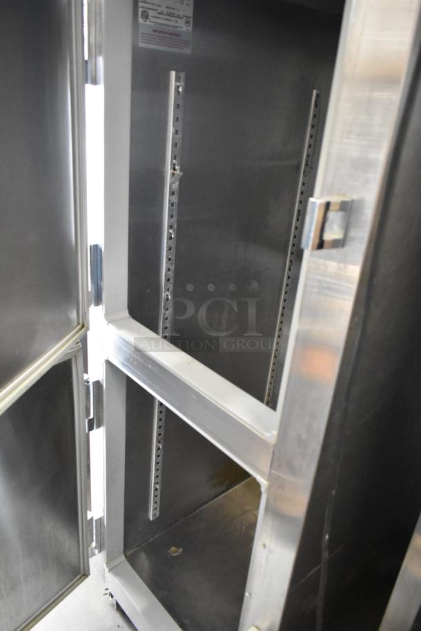 Traulsen stainless steel commercial cooler with two half-size doors on casters, 115V, 1 phase, excellent condition.