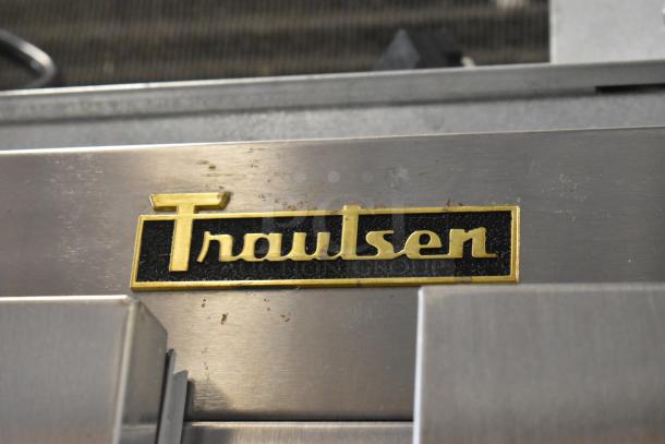 Traulsen logo on a 2018 ALT232NUT-HHS stainless steel commercial cooler, showcasing brand detail and craftsmanship.