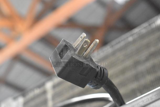 2018 Traulsen ALT232NUT-HHS plug, part of stainless steel commercial 4 half-size door cooler, 115V, black connector shown.