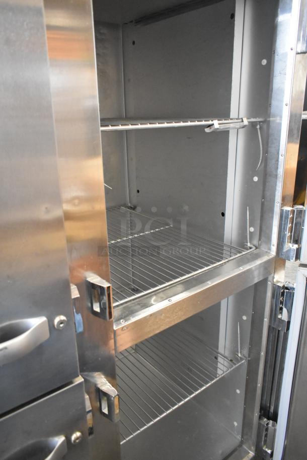 2018 Traulsen ALT232NUT-HHS stainless steel commercial cooler, 4 half-size doors, on casters, internal shelves visible.