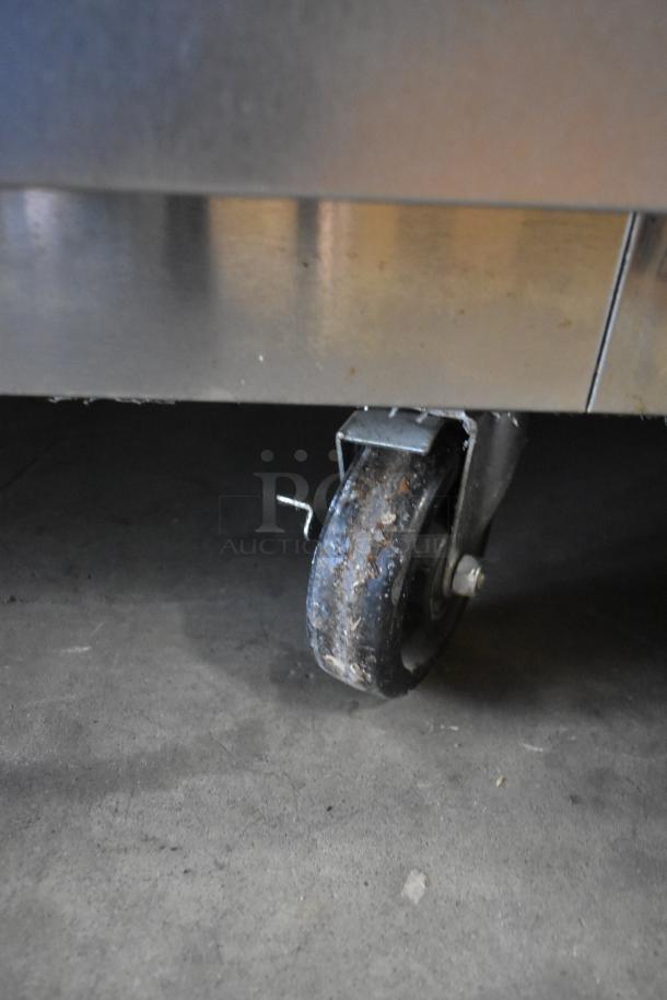 2018 Traulsen ALT232NUT-HHS stainless steel cooler caster, showing signs of use, on commercial flooring.