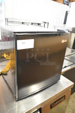 Seasons 189974 Mini Cooler in black, 115 volts, 1 phase, good condition. Visible label: "50." Suitable for compact spaces.