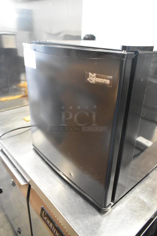 Seasons 189974 Mini Cooler, black, 115 volts, 1 phase, logo visible, minor wear on surface.