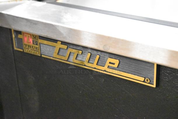True TD-50-18 stainless steel commercial back bar bottle cooler with two sliding lids and logo detail. 115V, 1 phase.